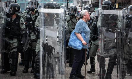 A woman shouts at police officers as they advance towards protesters in the Hong Kong district of Yuen Long on 27 July, 2019. Pro-democracy protests have continued on the streets of Hong Kong