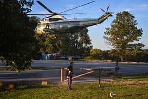 A Marine’s hat is blown off as US President Joe Biden takes off from Brandywine Creek State Park in Marine One in Wilmington