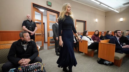 Paltrow enters the courtroom wearing a dark navy skirt paired with a cashmere-collared button-down.