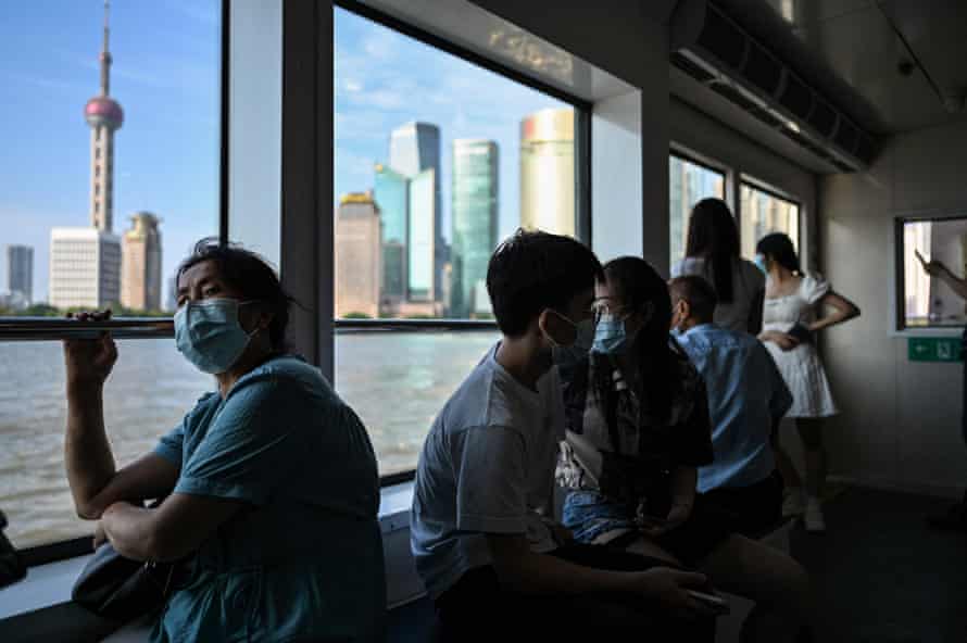 Passengers cross the Huangpu River on a ferry in Shanghai on 7 June following the easing of Covi restrictions.