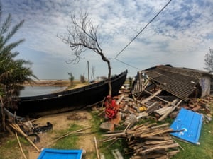 Kolkata, India: A woman sits on the remains of her house, which was destroyed by Cyclone Yaas.