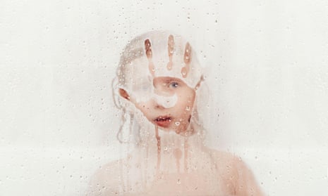 Little girl behind wet glass