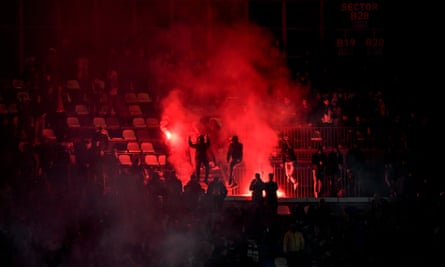 Napoli fans protest against the club president, Aurelio De Laurentiis, by lighting flares during the game against Milan.