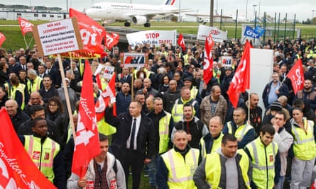 Striking Air France employees demonstrate in front of the company’s headquarters.