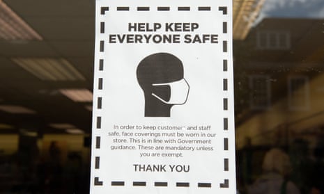 A sign in a shop window reading ‘Help keep everyone safe’, asking customers to wear a mask