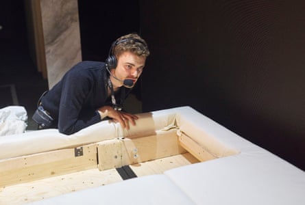 Assistant stage manager Ben Dootson prepares a secret compartment inside the bed.