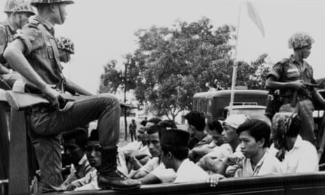 Members of the youth wing of the Indonesian Communist party are watched by soldiers as they are taken to prison in Jakarta on 30 October 1965.