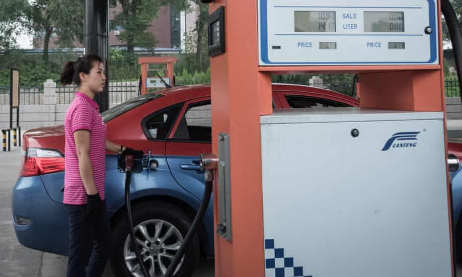 A petrol pump attendant fills up a taxi at a fuel station in Pyongyang.