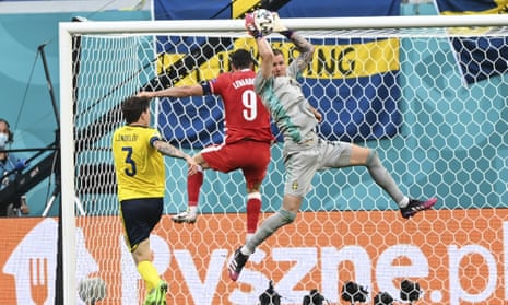 Sweden’s Robin Olsen thwarts Poland striker Robert Lewandowski at Euro 2020.