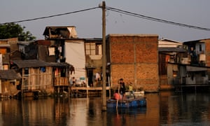 Children paddle a raft through waters in Jakarta, Indonesia