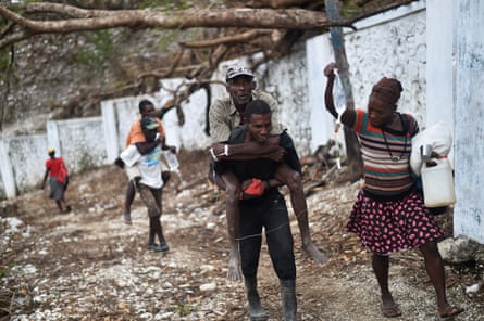 A man carries different man connected his back, arsenic a female holds an IV bag