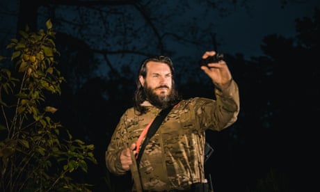 Jason Bullard of Mountain Wildlife Management hunts for armadillos with his hunting dog, Pete on a client's property in Sapphire, North Carolina.