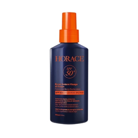 A bottle of Horace sunscreen. The bottle is navy blue with orange cap and text. It is on a white background