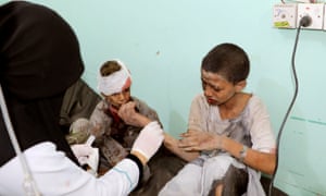 A doctor treats an injured child.