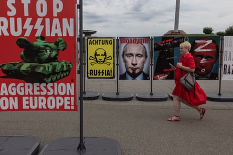 A woman visits an outdoor poster exhibition titled “The Victory Day” in Kyiv.
