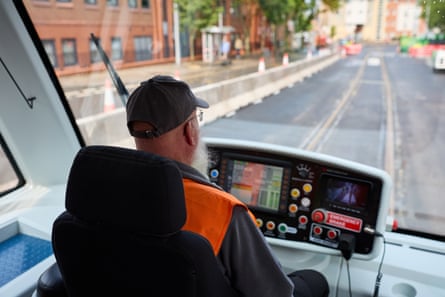 Graham Dibbins, a train driver at RailAdventure UK, steers a tram in the test phase