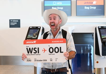 A passenger screams with excitement before boarding the first flight from the airport.