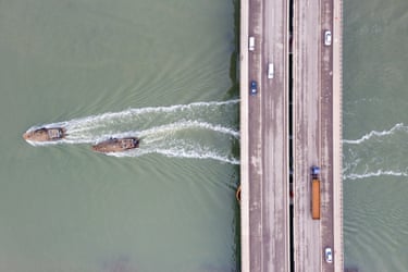 Fishing boats travel under a bridge near Tianjin