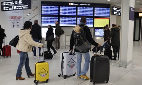 Passengers check flight information at Orly airport, Paris