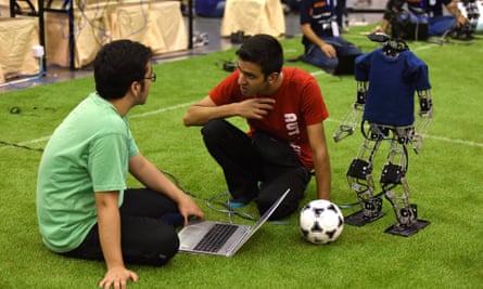 Robot programmers confer at Robocup 2015, in China.