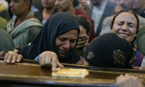 Relatives react during the funeral of one of the people killed after a bus carrying Coptic Christians was attacked in Egypt’s southern Minya province.