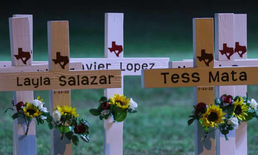 Each cross bears the name of a child and the date of their death, alongside an outline map of the state of Texas adorned with a heart.
