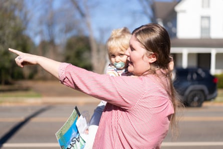 Haley Beverly, nextdoor neighbor of Jimmy Carter, points in the direction of his home in Plains.