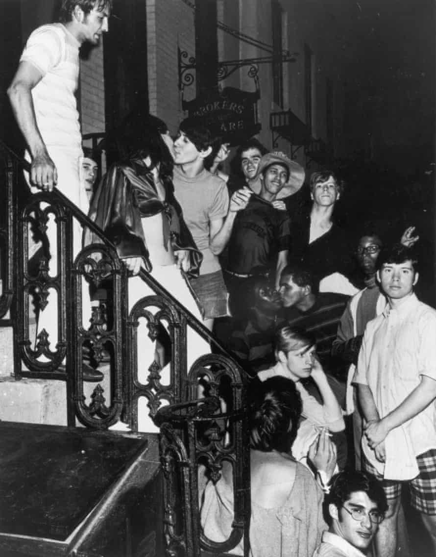 An unidentifed group of young poeple celebrate on a building stoop near the boarded-up Stonewall Inn (53 Christopher Street) after riots over the weekend of June 27, 1969. The bar and surrounding area were the site of a series of demonstrations and riots that led to the formation of the modern gay rights movement in the United States.