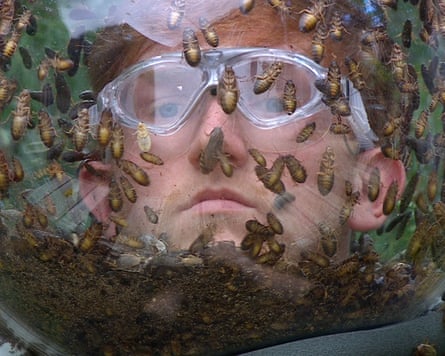 A man in a see-through mask filled with insects