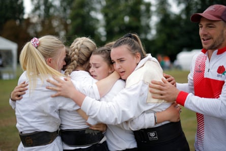 Some of the England team react after winning a bronze medal in the junior women’s 480kg competition.