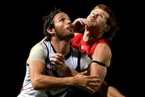 Cairns, Australia: James Aish of the Fremantle Dockers and Oskar Baker of the Melbourne Demons compete for the ball during an AFL match at Cazalys Stadium