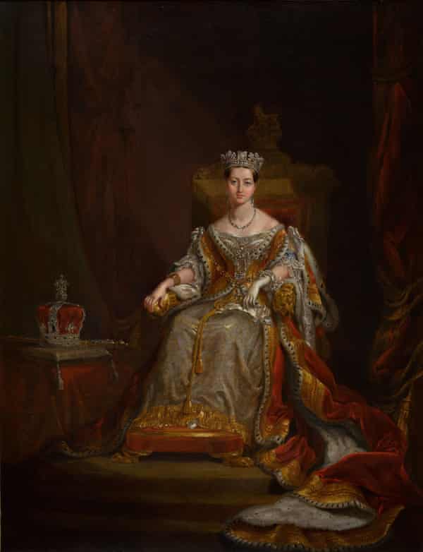 Queen Victoria seated on a throne with her feet on a cushion