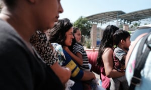 Dozens of women, men and their children, many fleeing poverty and violence in Honduras, Guatamala and El Salvador, arrive at a bus station following release from Customs and Border Protection on Saturday in McAllen, Texas. 