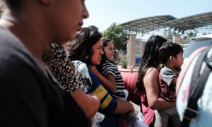 Dozens of women, men and their children, many fleeing poverty and violence in Honduras, Guatamala and El Salvador, arrive at a bus station following release from Customs and Border Protection on Saturday in McAllen, Texas.