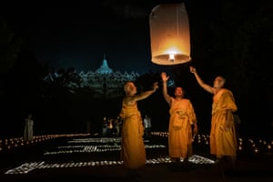 Buddhist monks release a lantern into the air at Borobudur temple, Magelang, Central Java, Indonesia.