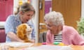Activity co-ordinator, Lydia Endersby, holds a robot dog next to Frances Barrett, a resident at Oak Manor care home