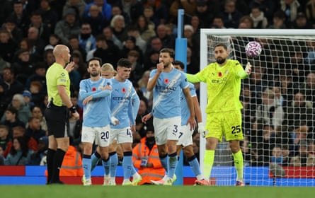Gianluigi Donnarumma and his Manchester City teammates remonstrate with Anthony Taylor over Bournemouth’s goal.