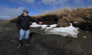 Rick Knecht, an archeologist, shows a site threatened by climate breakdown erosion caused by melting permafrost on the Yukon Delta in Alaska.