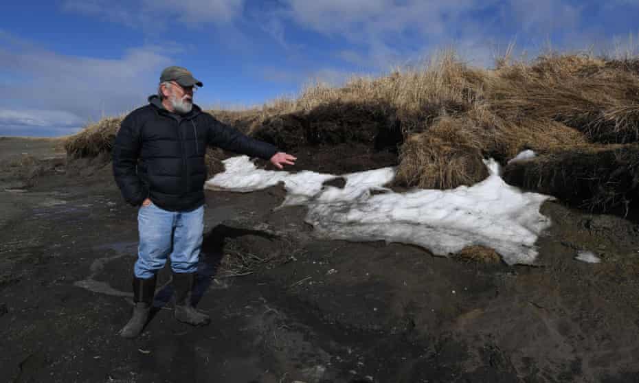 Rick Knecht, an archeologist, shows a site threatened by climate breakdown erosion caused by melting permafrost on the Yukon Delta in Alaska. 