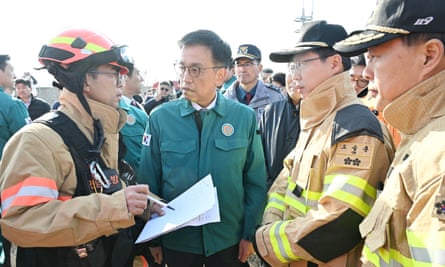 South Korea in mourning after plane crash kills all but two onboard 3 Choi Sang-mok with firefighters at the crash scene