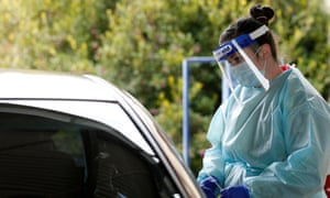 A nurse performs a coronavirus test at a drive-through clinic in Ballarat, Victoria.