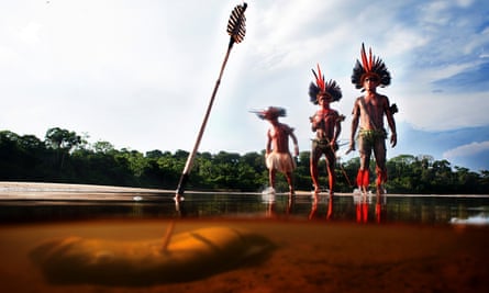 Indigenous people fishing with bow and arrow in the river with the Asurini do Tocantins tribe in the Brazilian Amazon. Conservation scientists have realized that often the best defenders of ecosystems are indigenous tribes.