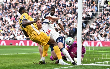 Tottenham’s Micky van de Ven hits his own post as he attempts to clear the danger.