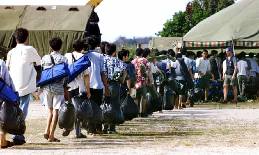 Asylum seekers from Afghanistan arriving at a camp on the island of Nauru after attempting to reach Australia, in September 2001.
