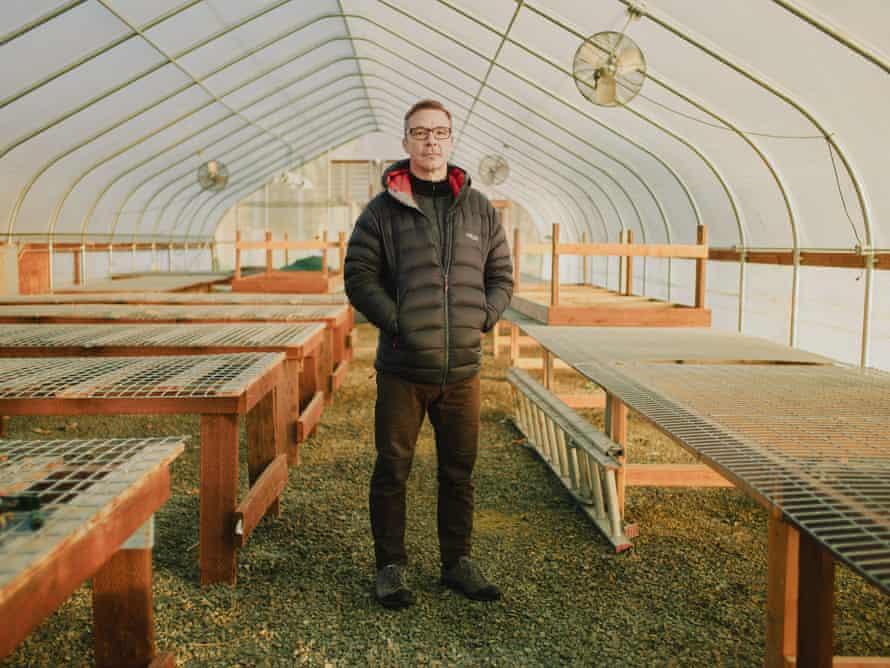 A man stands for a portrait in a marijuana grow house