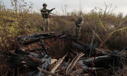 Ukrainian servicemen inspect the former position of Russian troops, in the Zaporizhzhia area