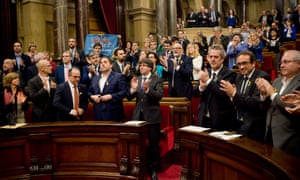 Carles Puigdemont and parliamentarians applaud at the end of the session at the plenary room of the Catalonian parliament after declaring independence.