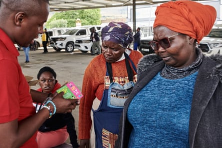 Prof Mtembu, a TAC trainer, talks to group of commuters at a local taxi rank in Matatiele, Eastern Cape. The trainers go into rural areas, often handing out the books dor-to-door.