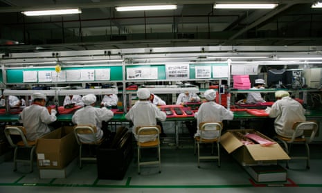 Workers are seen inside a Foxconn factory in the township of Longhua, in China’s Guangdong province.