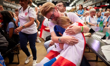 A mother consoles a young fan at Boxpark as England lose the Fifa Women’s World Cup final.